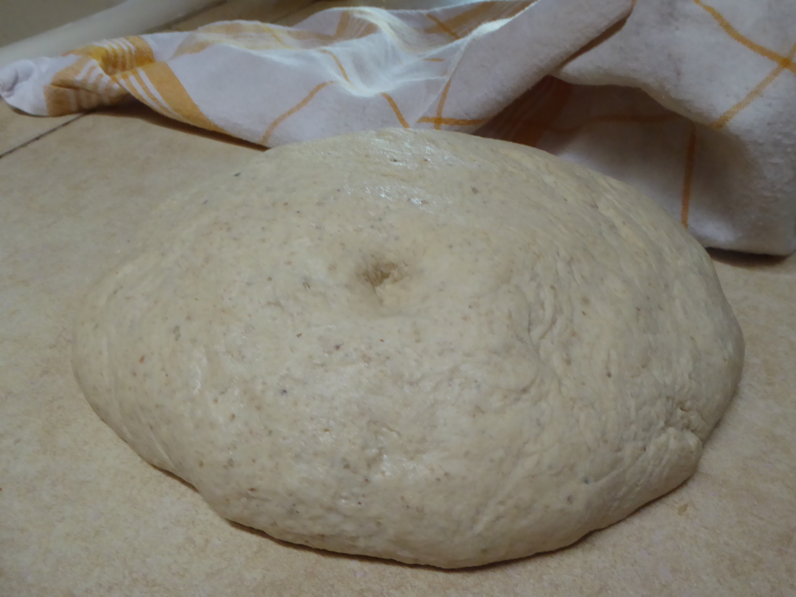 poked bread dough focused